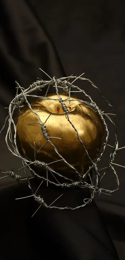 Golden apple wrapped in barbed wire on a dark background.