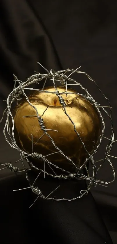 Golden apple wrapped in barbed wire on a black background.