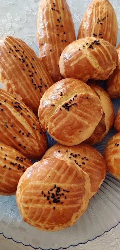 Golden baked pastries with sesame seeds on a plate.