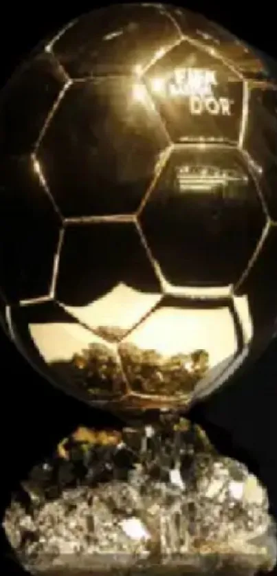Golden Ballon d'Or trophy on black background.