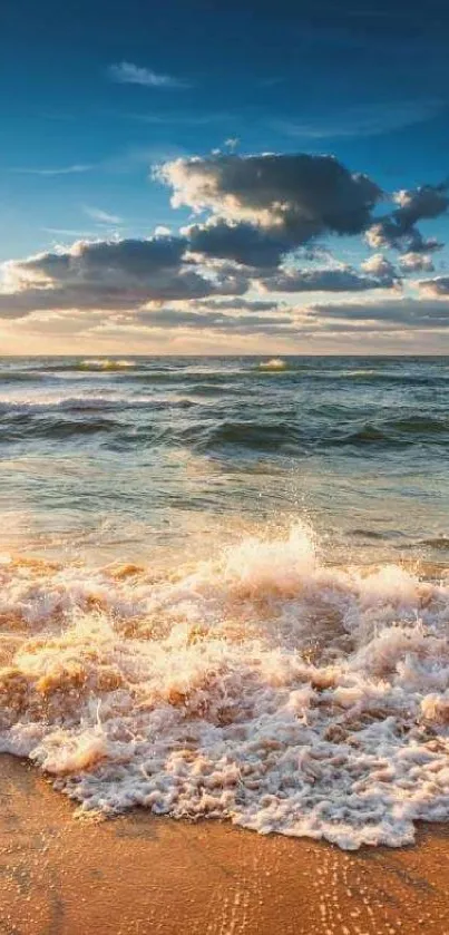 Golden sunset over a tranquil ocean beach with waves and clouds.