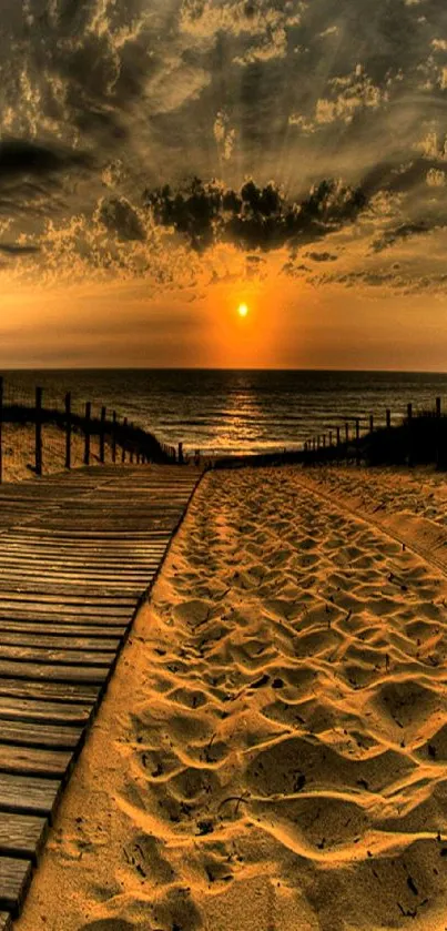 Golden sunset over beach with wooden path and ocean view.