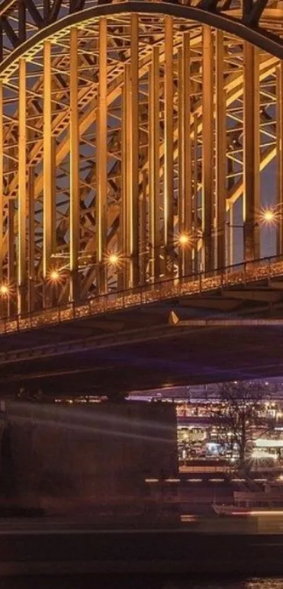 Golden arch bridge illuminated at night.