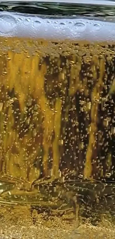 Golden beer bubbles rising in a glass on a vibrant mobile wallpaper.