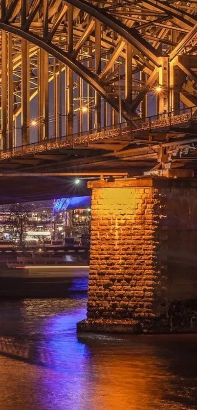 Golden bridge illuminated over water at night, perfect for mobile wallpaper.