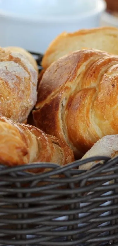 Freshly baked croissants in a wicker basket, perfect for food lovers.