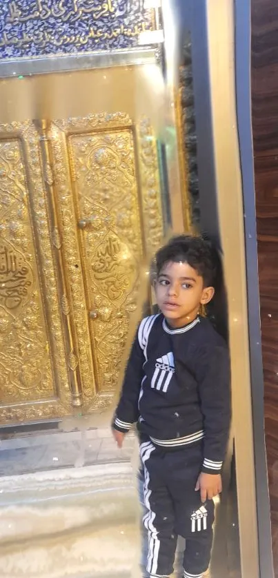 Child standing beside a golden ornate door.