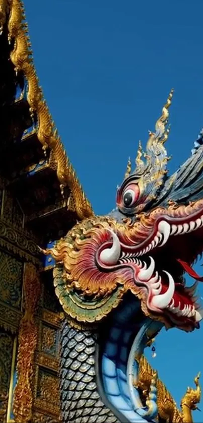 Golden dragon sculpture against a vivid blue sky.