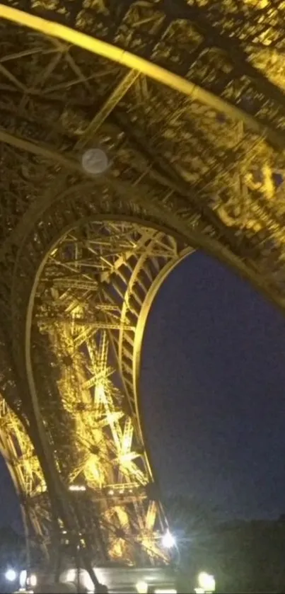 Golden nighttime view of the Eiffel Tower.