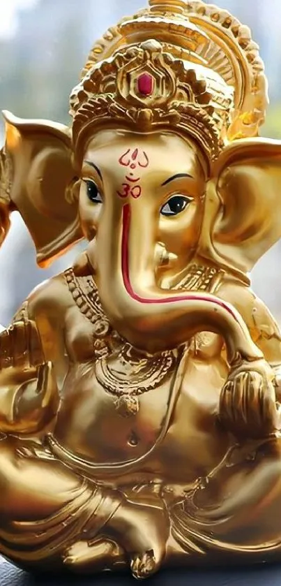 Golden Lord Ganesha statue for mobile wallpaper.