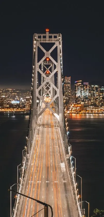 Golden Gate Bridge illuminated at night with city lights.