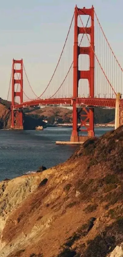 Golden Gate Bridge at sunset with coastal cliffs.