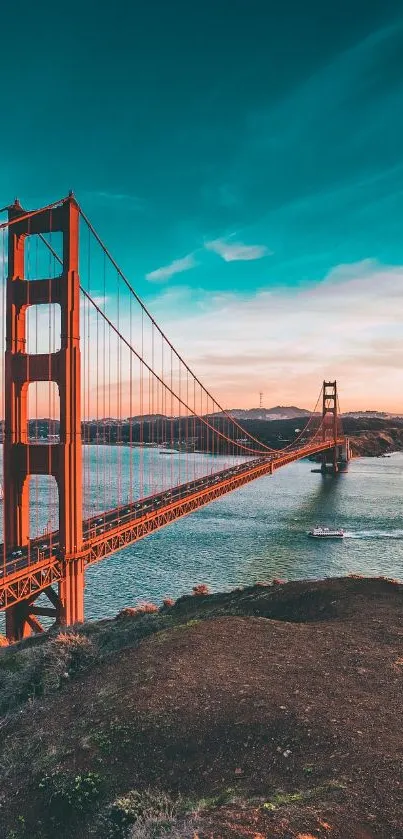 Golden Gate Bridge under a vibrant sunset sky over water.