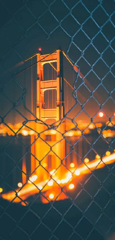 Golden Gate Bridge at night with orange glow and fence pattern.