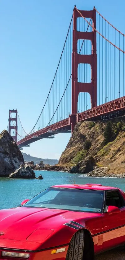 Red sports car near Golden Gate Bridge under clear sky.