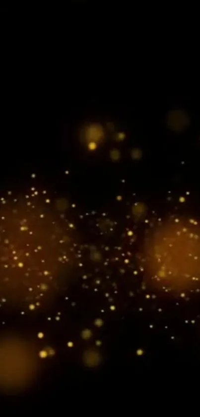 Golden glitter wallpaper with sparkling particles on a black background.