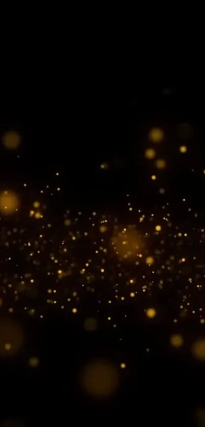 Golden glitter sparkles on a black background for mobile phone wallpaper.