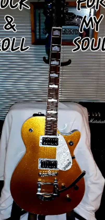 Golden electric guitar with 'Rock & Roll For My Soul' text on a wallpaper.