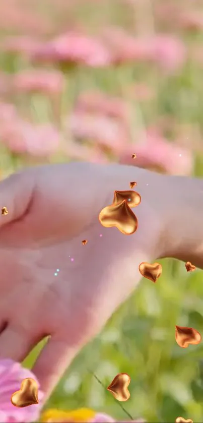 Hand with golden hearts in a colorful flower field.