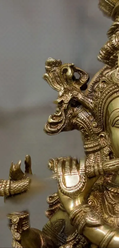 Intricate golden Hindu deity statue artwork.