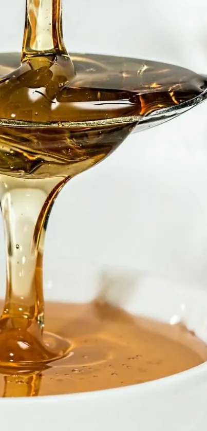 Close-up of honey drizzling from a spoon into a bowl, showcasing golden hues.