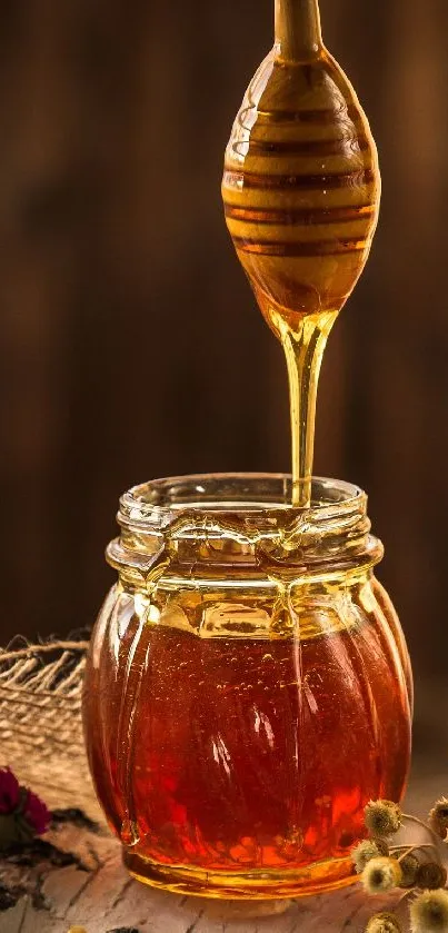 Golden honey dripping into a glass jar with rustic decorations.