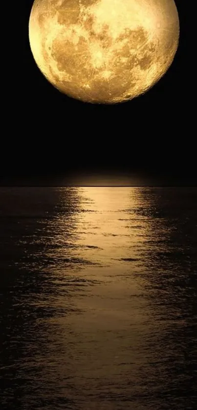 Golden full moon reflecting over tranquil water.