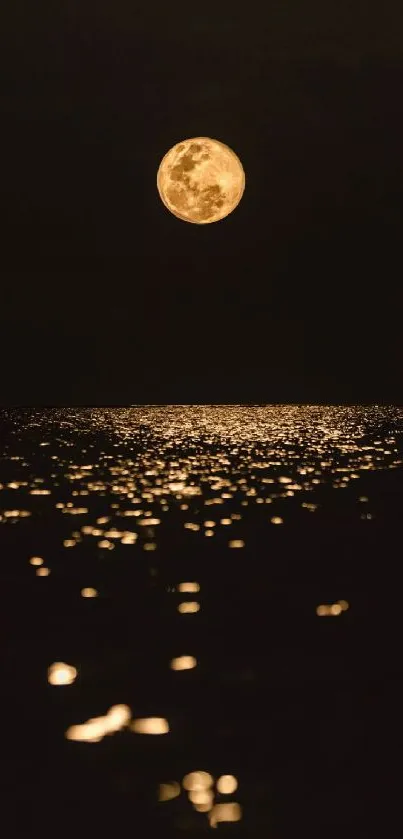 Golden full moon reflecting on a dark ocean under a starless sky.