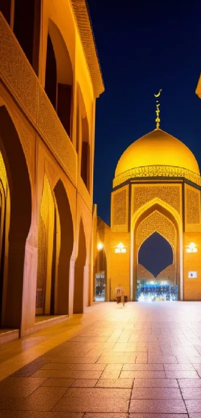 Golden mosque illuminated at night under a dark blue sky.