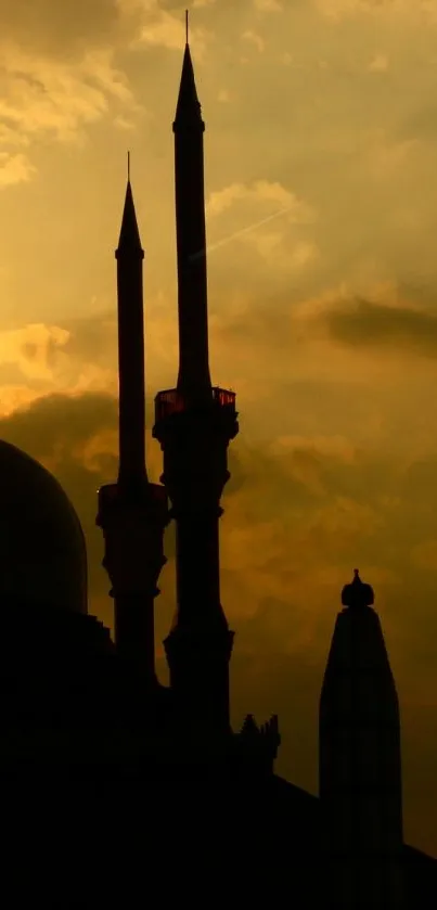 Mosque silhouette against a golden sunset sky.