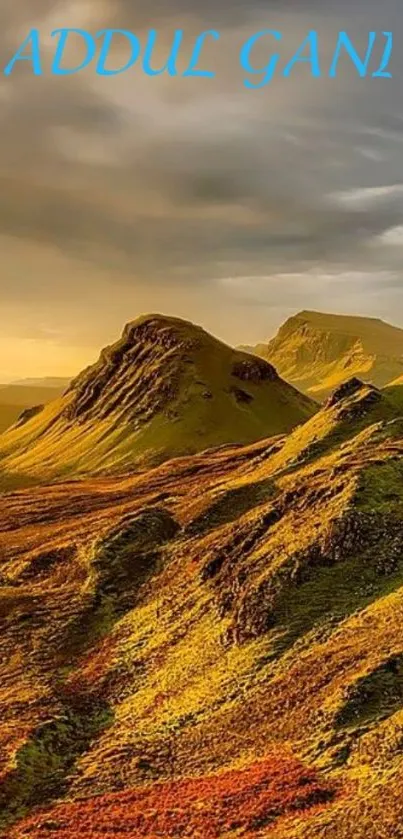 Golden mountains under a dramatic sky in stunning mobile wallpaper.