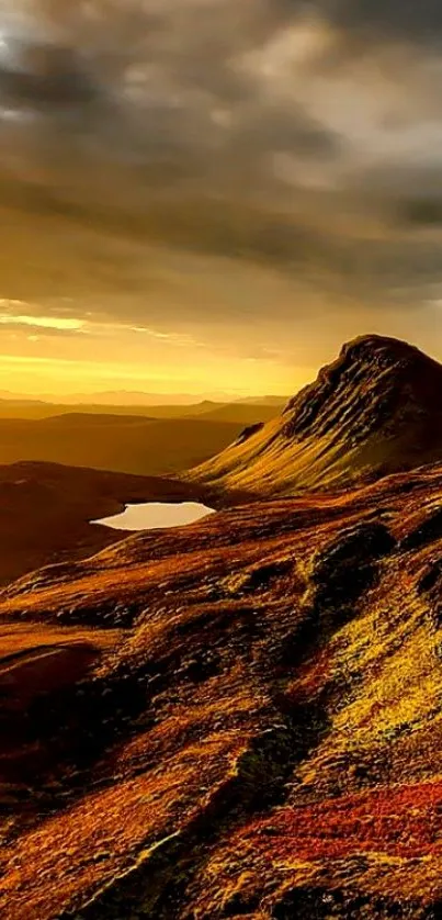 Golden mountains at sunset with dramatic sky.