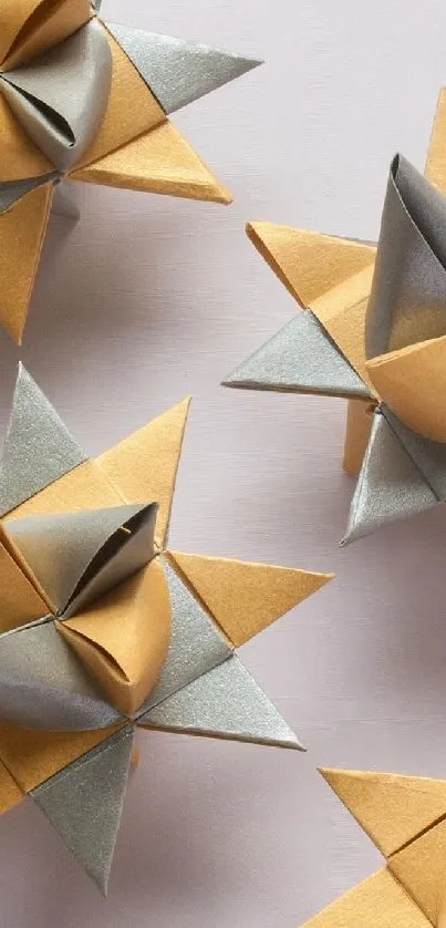 Golden and silver origami stars on a minimalist background.