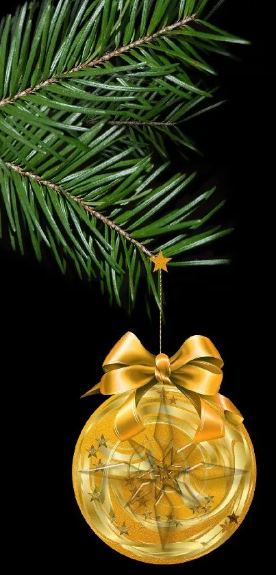 Golden ornament with ribbon hanging on a pine branch, set against a black background.