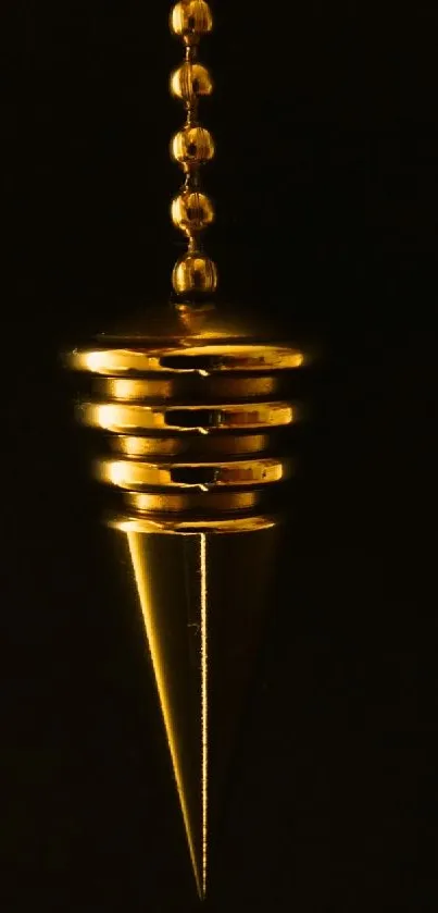 Golden pendulum on dark background mobile wallpaper.