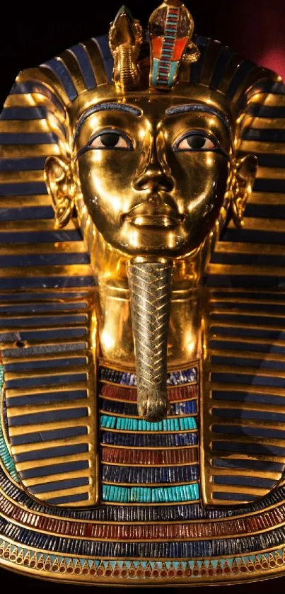 Golden Pharaoh mask against a dark background.