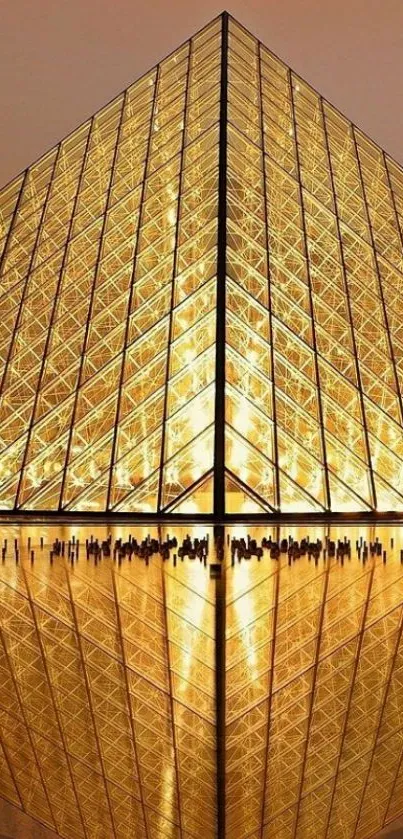 Golden pyramid with reflection under warm light, creating an elegant design.