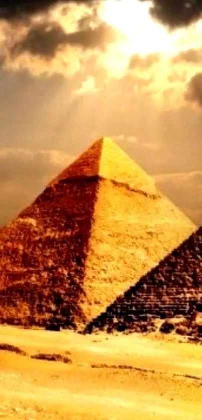 Golden pyramid under a dramatic sunset sky with clouds.