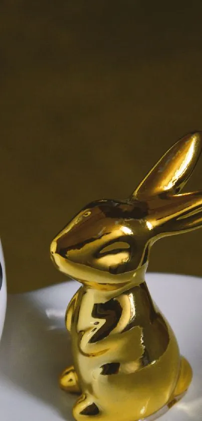 Golden rabbit figurine on minimalist background for mobile wallpaper.