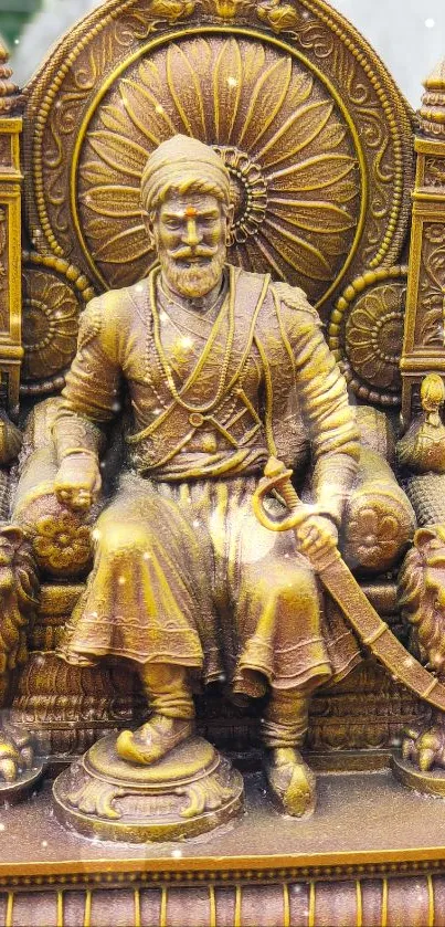 Golden sculpture of a regal figure on a throne with intricate details.