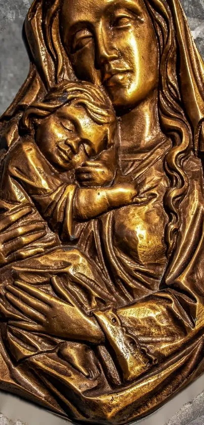 Golden bronze icon of mother and child on a detailed textured background.