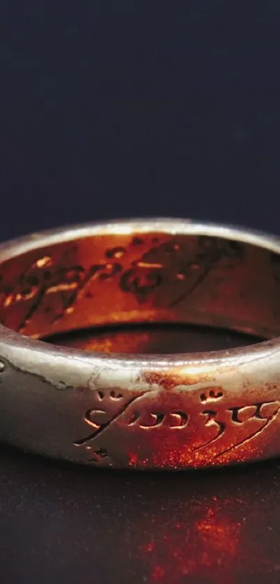 Golden ring with inscription on dark surface