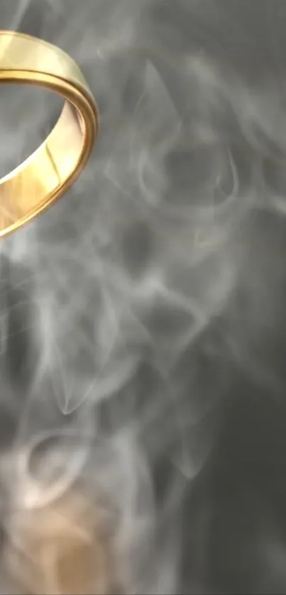 Golden ring amidst swirling smoke on dark background.