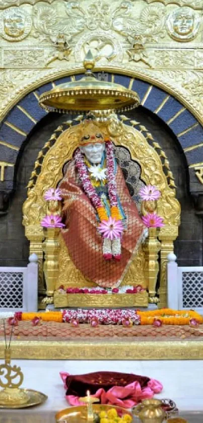 Golden Sai Baba shrine adorned with flowers and intricate designs.