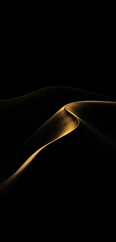 Golden sand dunes gracefully curving in darkness.