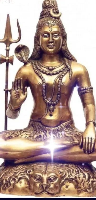 Golden statue of Shiva with trident, radiating a spiritual aura.