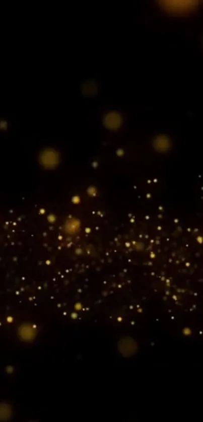 Abstract wallpaper with golden sparkles on a black background.