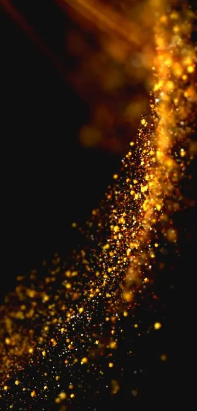 Abstract image with golden sparkles on a dark background.