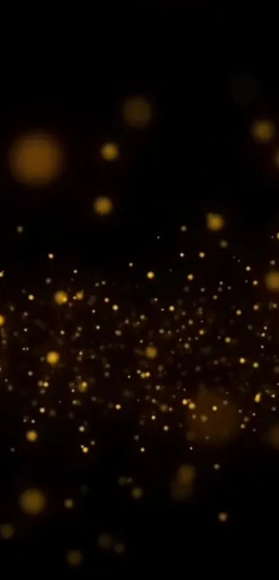 Golden sparkle abstract wallpaper with dark background of glowing particles.