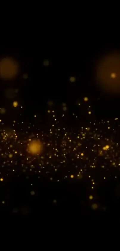 Golden sparkles on a black background wallpaper.